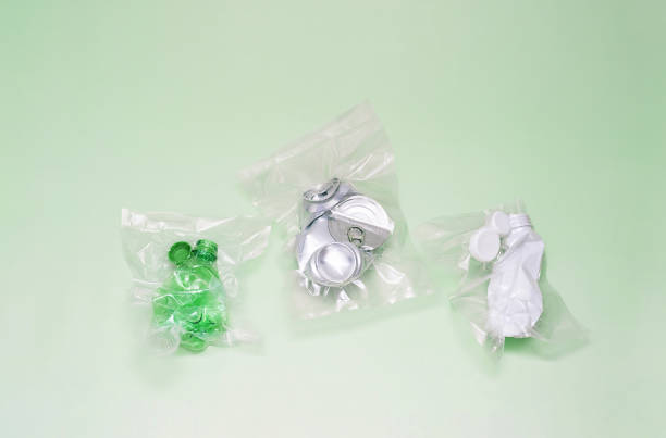 istock Crushed aluminum cans and plastic bottles vacuum-sealed, symbolizing urgent environmental waste crisis. 2197339382
