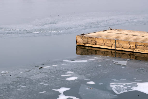 wooden pier on frozen lake