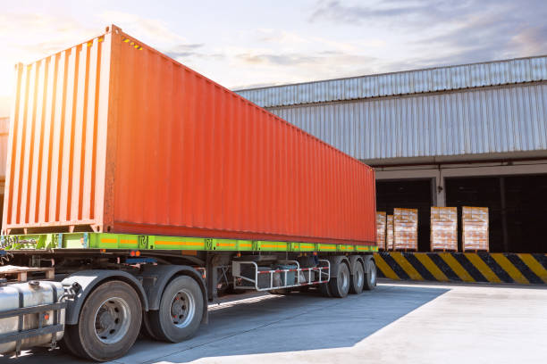 istock Container Trucks Loading at Warehouse Dock. Bulk of Package Boxes to be Loaded into Shipping Containers. Distribution Warehouse. Supply Chain, Shipment. Freight Truck Logistics Transportation. 2197340468
