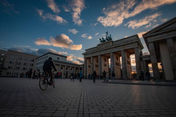 istock Brandenburg Gate at sunset with people and cyclist. 2197344400