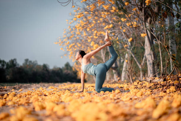 istock Woman practicing an advanced yoga pose outdoors in a picturesque autumnal setting  tranquil and inspiring scene conveys a sense of mindfulness, connection with nature, and the pursuit of physical and mental harmony. 2197346206