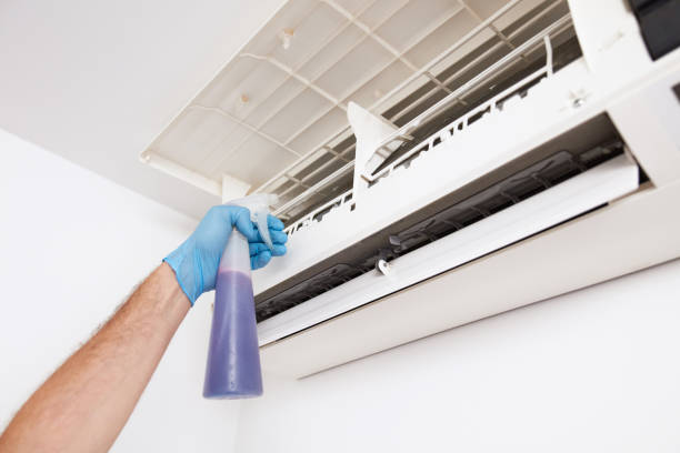 istock Man cleaning and maintaining air condition unit at home. 2197347060