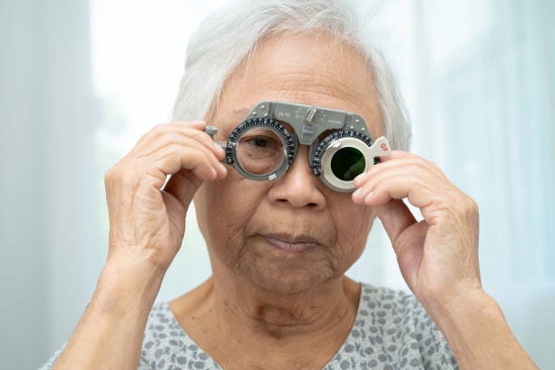 istock Asian senior woman wearing ophthalmic vision eye test and using optical trial frame. 2197347716