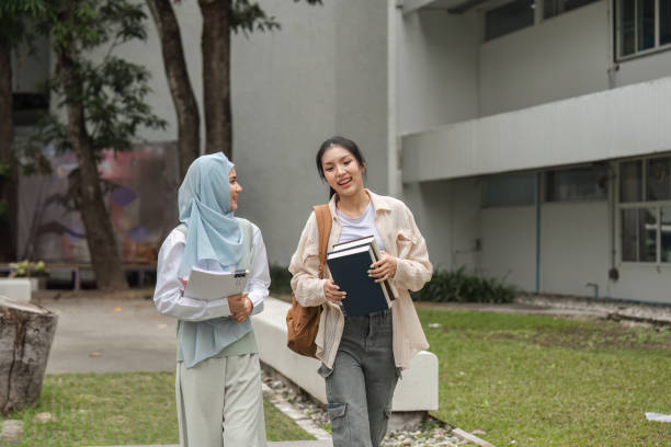 istock Diverse university students walking and chatting together on campus. 2197347984
