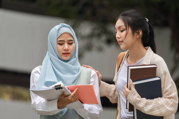 istock Diverse college students discussing studies, sharing support and friendship outdoors. 2197348117