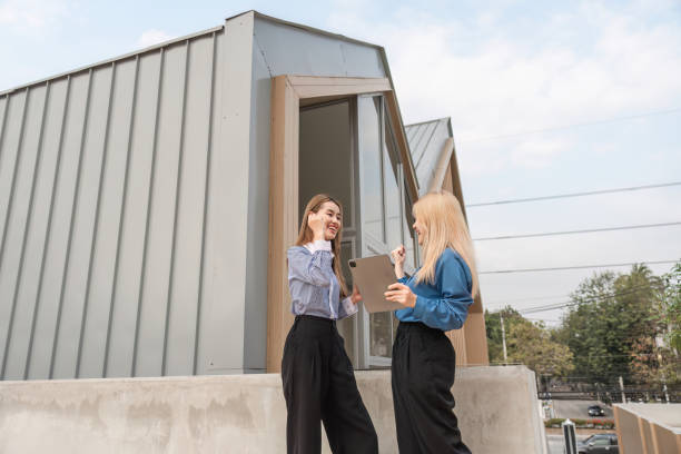 istock Diverse women discussing ideas enthusiastically with a tablet outdoors in a modern setting. 2197348161