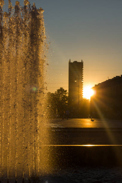 istock Orange sunset in a park with fountains 2197348283