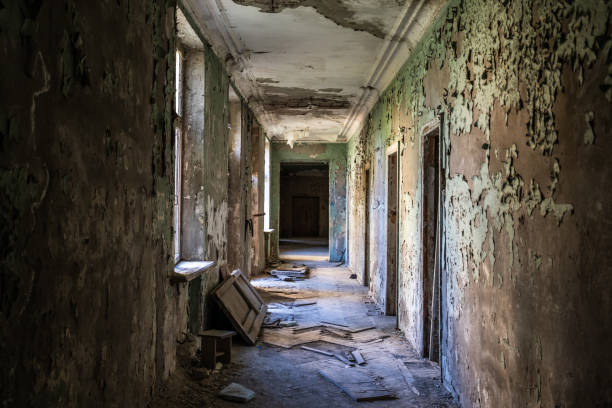 istock Abandoned hallway bathed in soft sunlight, with peeling paint and scattered debris. Contrast between neglect and hope, reflecting concepts of time, memory, and renewal 2197348335