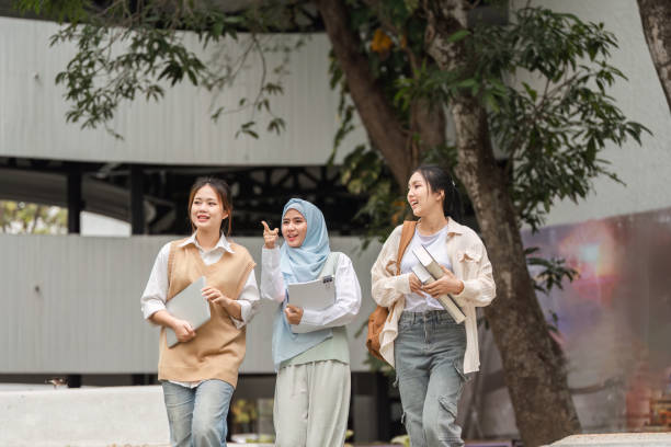 istock Diverse trio of college students walking together, engaged in conversation on campus. 2197348652