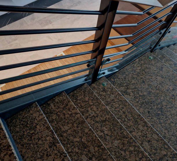 istock glass is attached to the wall using screws and washers intended for drilling into glass. the cladding is a railing and an air partition in the station hall, tower block, combination 2197349736