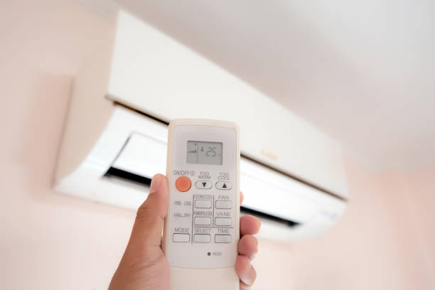 istock Close up hand and remote control air condition. 2197350478