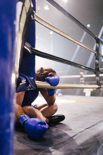 istock Exhausted Female Boxer Resting On Ropes 2197351038