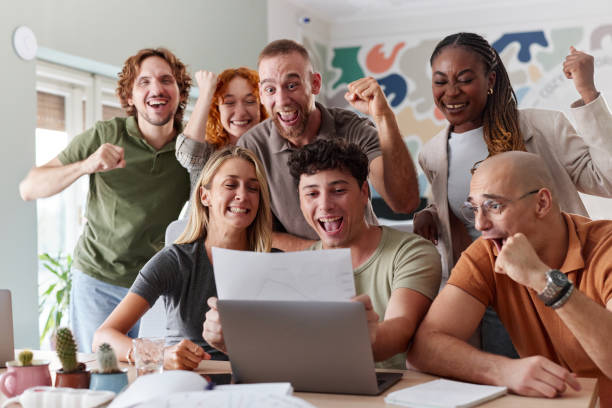 istock Cheerful creative team celebrating their success in the office. 2197351221