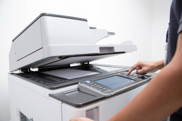 istock Closeup hand press button to using the photocopier or xerox machine is office work tool printer equipment in copy room for scanning document and print a paper. 2197352136
