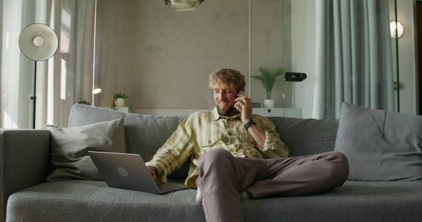 istock A man uses a laptop at home 2197352150