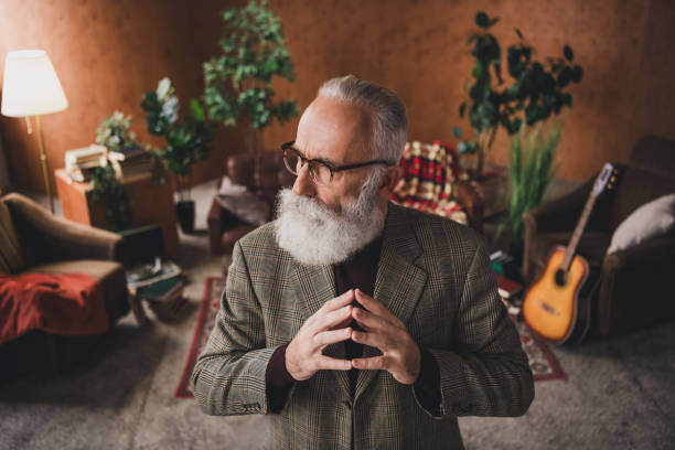 istock Sophisticated senior man with white beard posing in retro-inspired cozy apartment interior 2197352294