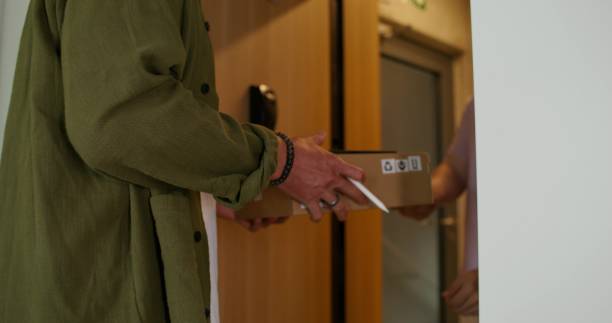 istock A man receives a delivery at home 2197352642