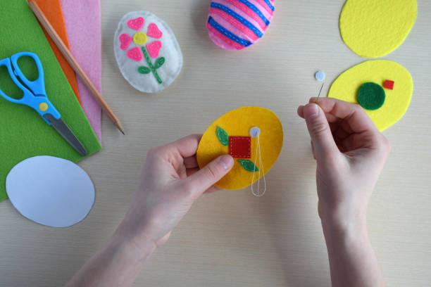 istock Making handmade easter eggs from felt with your own hands. Childrens DIY concept. Easter decoration 2197352953