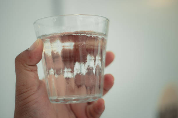 istock A glass of water on man hand 2197353413