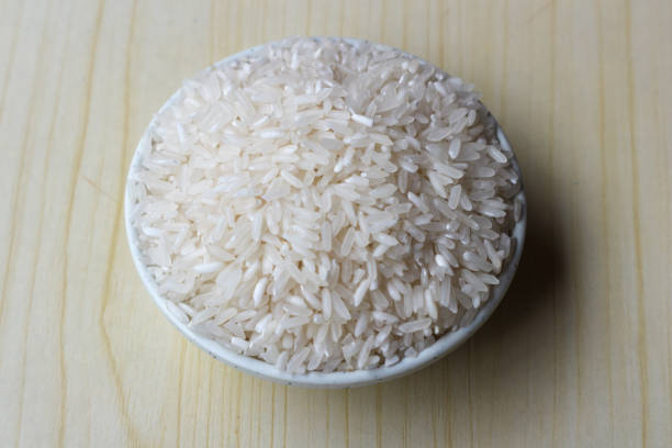 istock Raw rice in white bowl on wooden background 2197354128