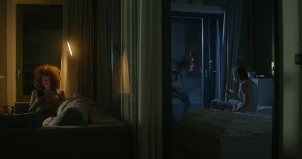 istock A man and a woman use mobile phones at night 2197354325