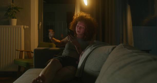 istock A woman uses a mobile phone at home 2197354351