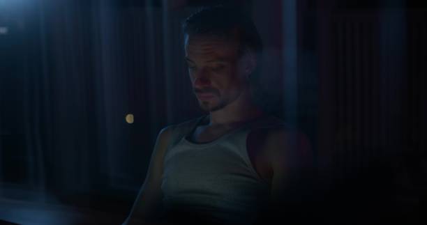 istock A man uses a laptop at night 2197355559