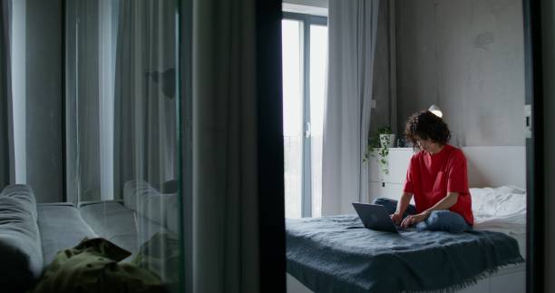 istock A woman uses a laptop at home 2197355849