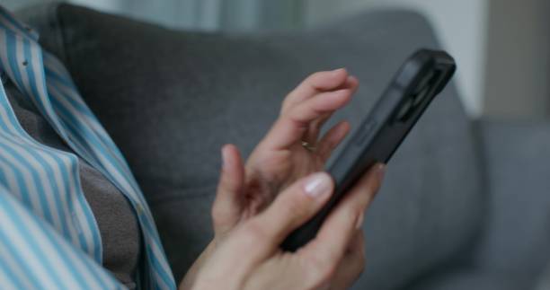 istock A woman uses a mobile phone 2197356189