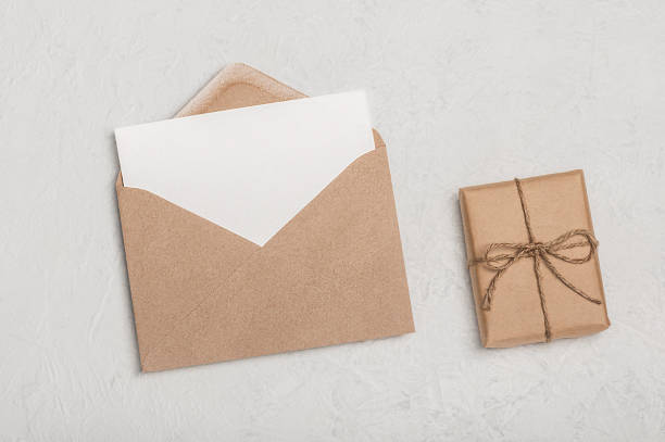 istock Invitation or greeting card mockup, craft envelope and craft gift box on light background. Minimalistic congratulation. 2197356812