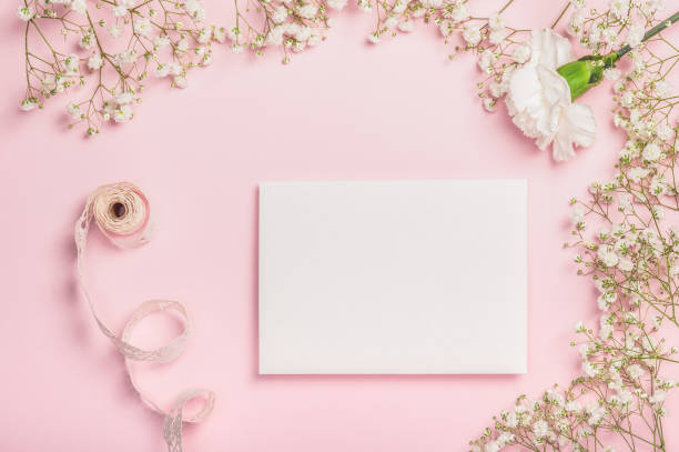 istock Flat lay composition with empty letterhead, gypsophila and white carnation on pink background. 2197356997