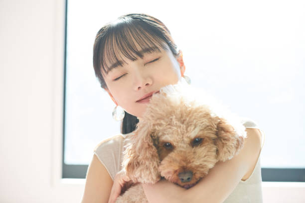 istock Young Asian woman with her dog 2197357498