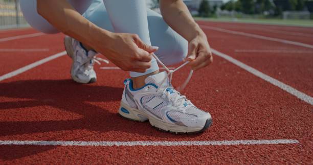 istock A woman ties her shoelaces 2197358633