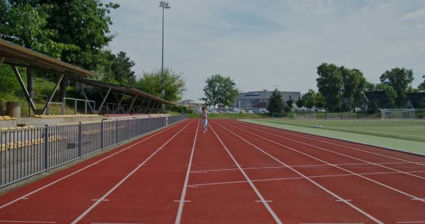 istock A woman runs in the stadium 2197358684