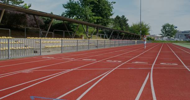 istock A woman runs in the stadium 2197358829