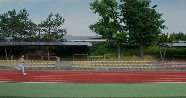 istock A woman runs in the stadium 2197358930