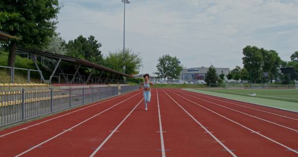 istock A woman runs in the stadium 2197359140