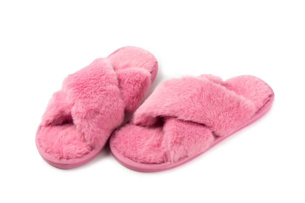 istock Soft slippers on a bright colored background, close-up. House slippers. Comfortable shoes for home. Foot care concept. Home comfort. Space for text. Copy space. 2197359600