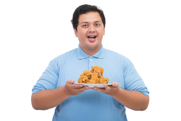 istock Fat man holding a plate of fried chicken 2197360473
