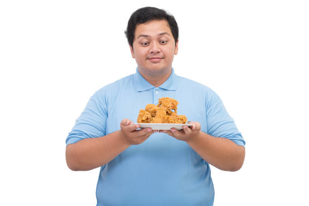 istock Fat man holding a plate of fried chicken 2197360478