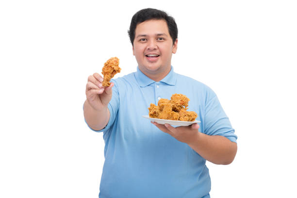 istock Fat man holding a plate of fried chicken 2197360481