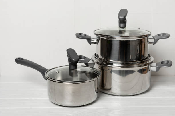 istock Stainless steel saucepan on light kitchen background. Modern saucepan. Kitchenware. Cooking pot. Cooking concept. Mockup. Space for text. Copy space. 2197360563