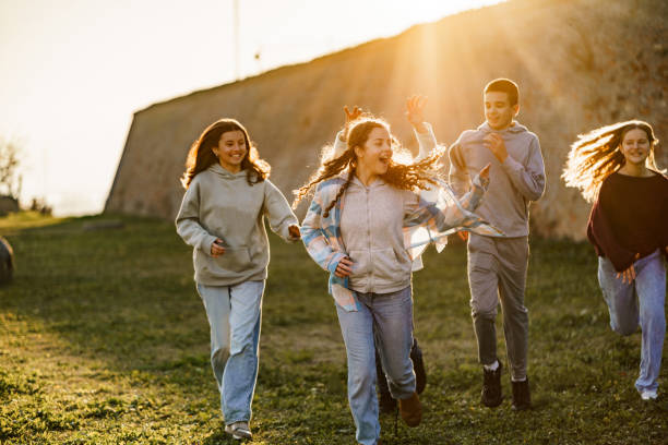 Teenagers having fun running outdoors