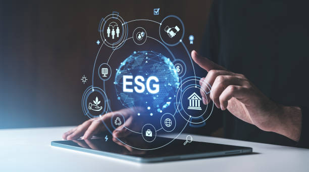 istock Hands interacting with digital ESG icons above a tablet. Dark background. Concept of environmental, social, and governance strategies 2197363765