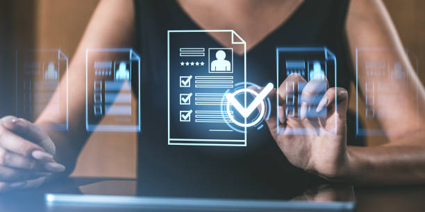 istock Woman interacting with digital holographic documents with checklists and profiles in a futuristic workspace, wearing black outfit. 2197363852