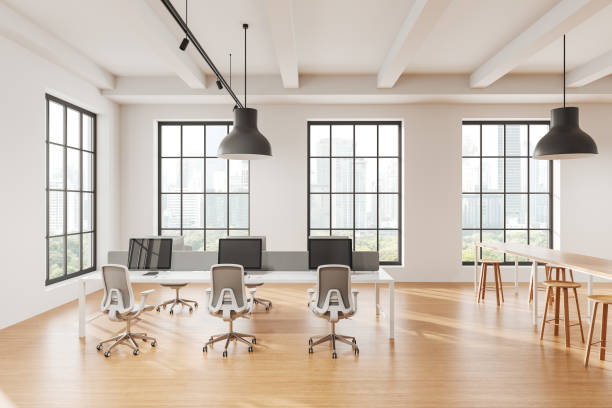 istock Modern office workspace with large windows, bright lighting, and minimalist furniture setup. 3D Rendering 2197364109