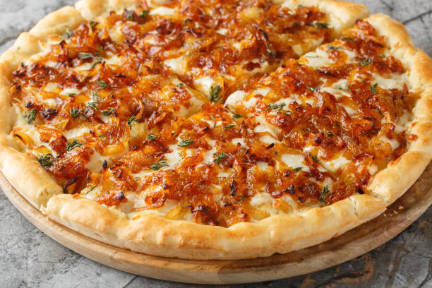 istock French onion pizza is basically a portable version of French onion soup, complete with both Gruyere and mozzarella cheese closeup on the wooden board. Horizontal 2197368747
