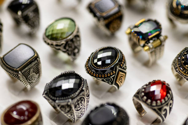 Close-up of a group of various colorful gemstone rings in a jewelry store.