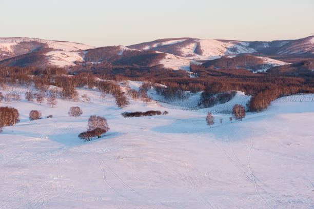 Overlooking the snowy grasslands and the beautiful sunset