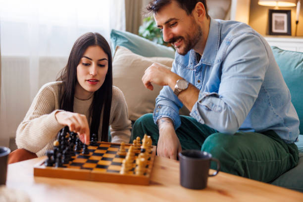 istock Couple in love playing chess at home 2197370598